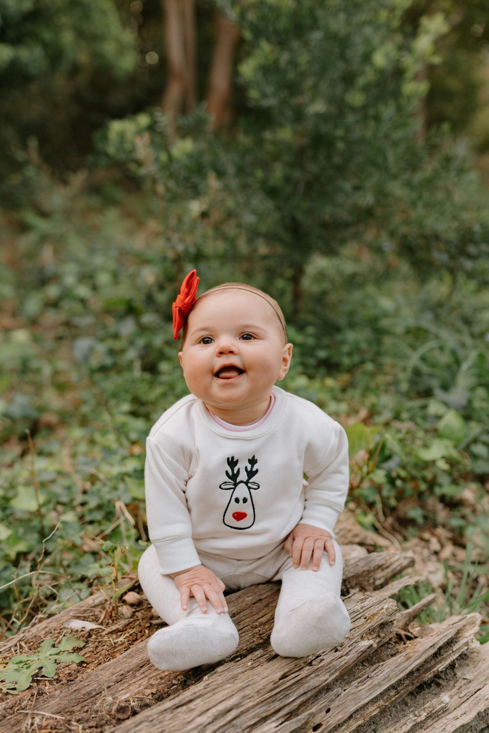 Embroidered Christmas baby clothing by Dale Raine, crafted in Cape Town for soft, sustainable kids wear.