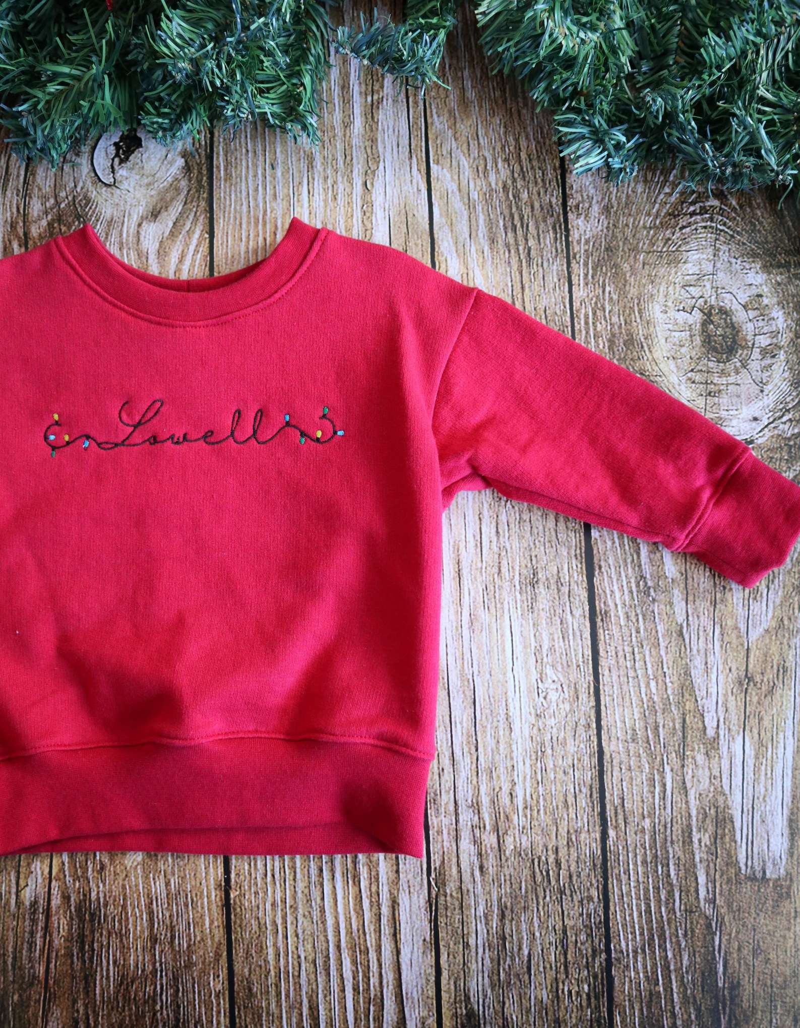 Custom-made personalised Christmas crew neck sweater with embroidery, crafted by Dale Raine in Cape Town for stylish leisurewear.