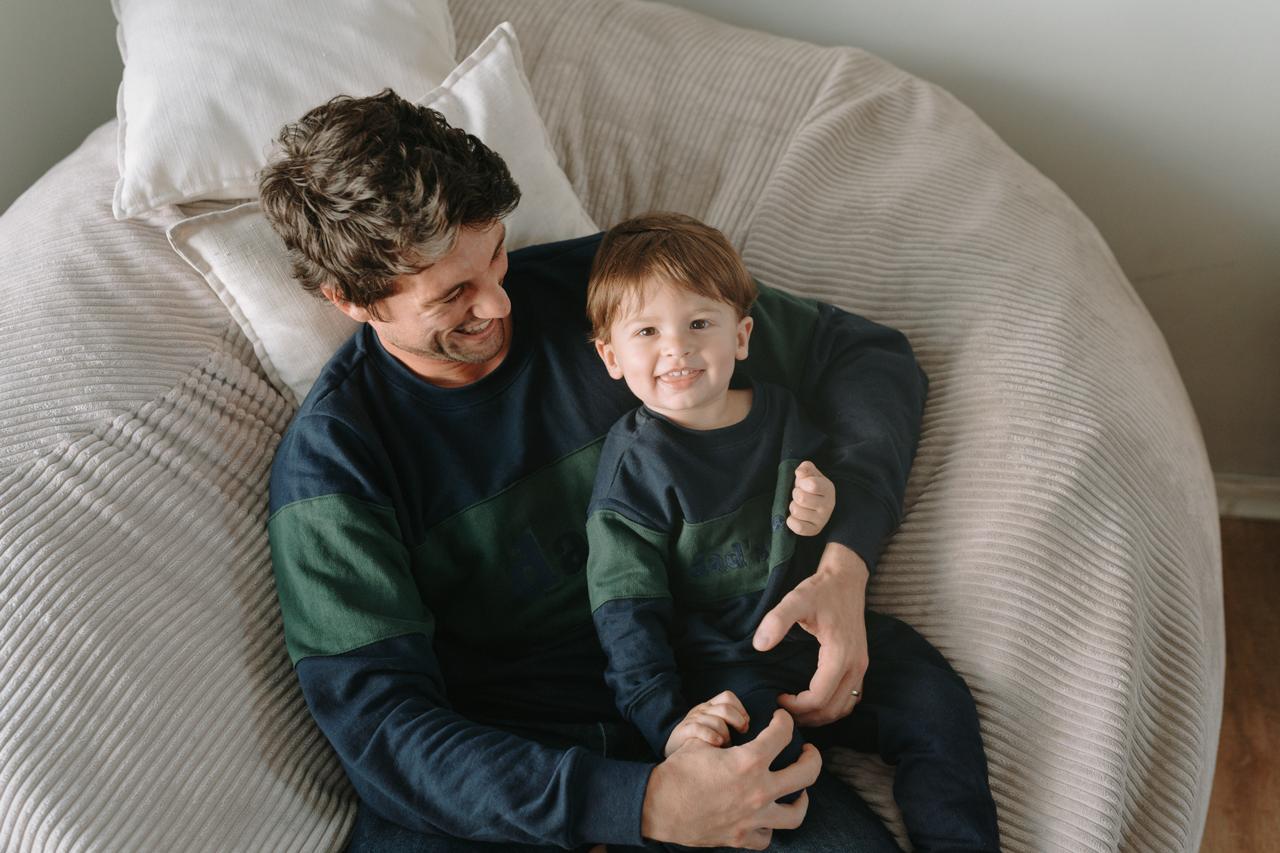 Father and son wearing Dale Raine’s comfortable embroidered two-tone sweaters, locally handmade in Cape Town for everyday style.