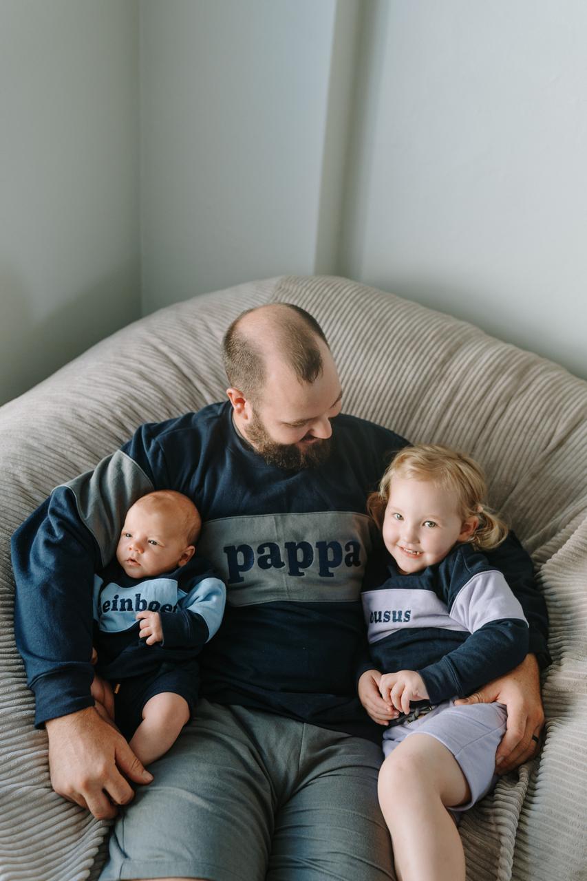 Father, daughter and baby son wearing Dale Raine’s comfortable embroidered two-tone sweaters, locally handmade in Cape Town for everyday style.